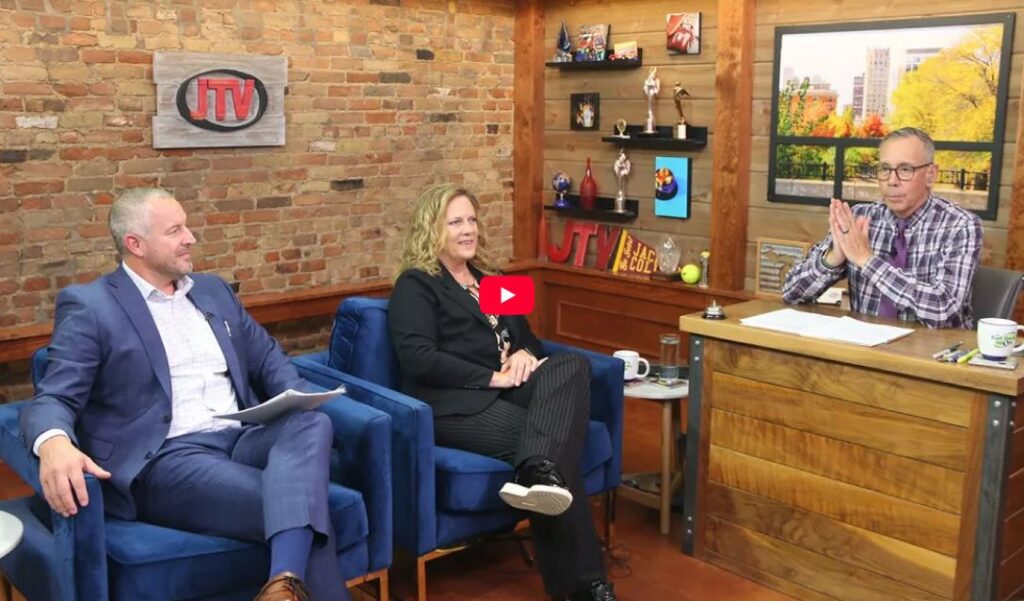 Chelsea State Bank's SVP Tom DuMont and VP Erin DuBois sitting in JTV's studio looking at Bart Hawley