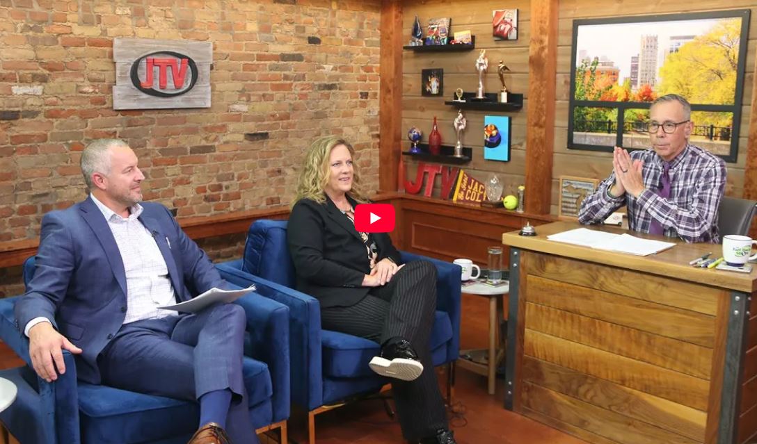 Chelsea State Bank's SVP Tom DuMont and VP Erin DuBois sitting in JTV's studio looking at Bart Hawley